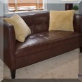 F33. Leatherette loveseat. 30”h x 62”w x 30”d 